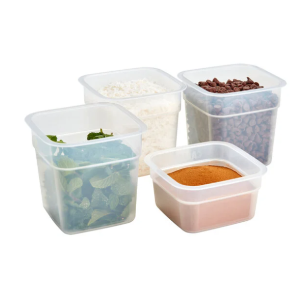 Mini food storage containers containing spinach, spices, white chocolate chips, and milk chocolate chips.