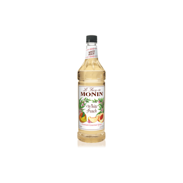 Monin White Peach Syrup bottle with label visible.